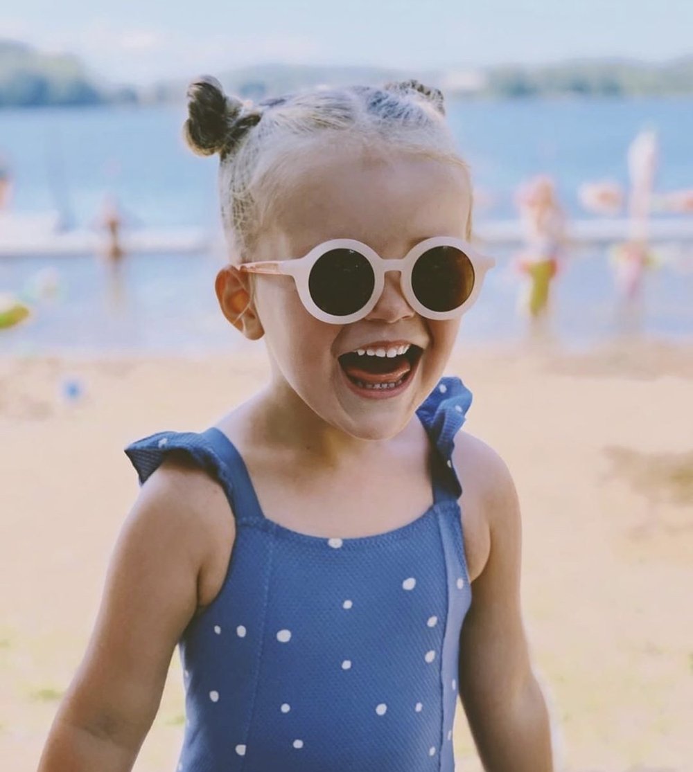 little girl with white round Sunglasses made from recycled plastic