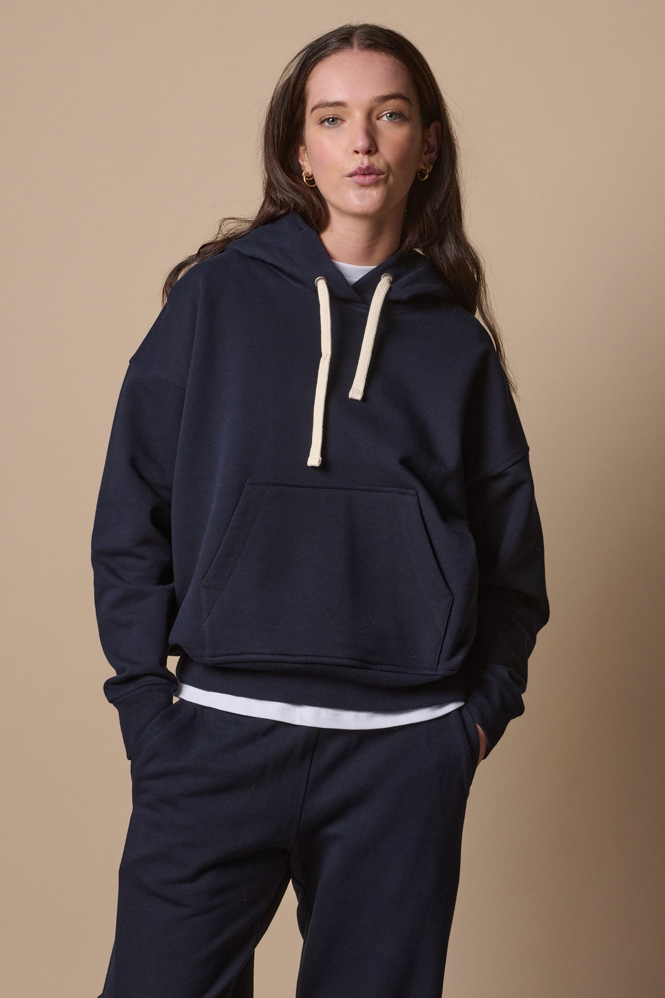 pouting female wearing hooded sweatshirt in navy